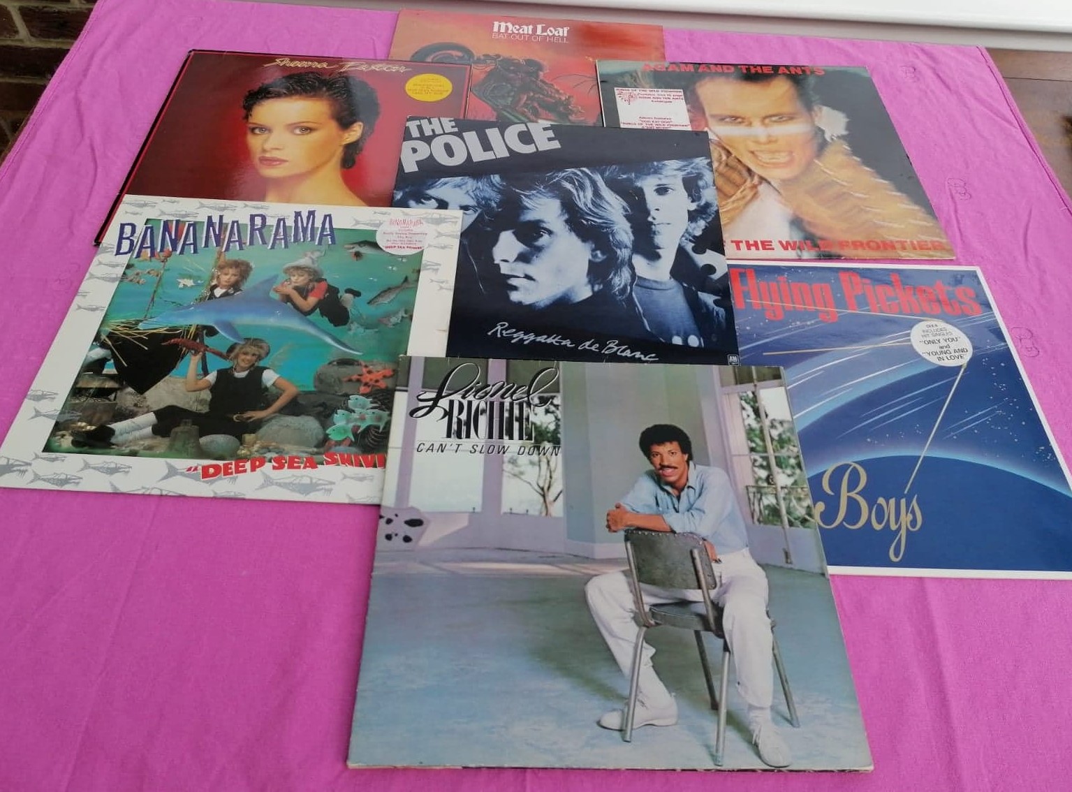 An image of vinyl records laid out on a table.