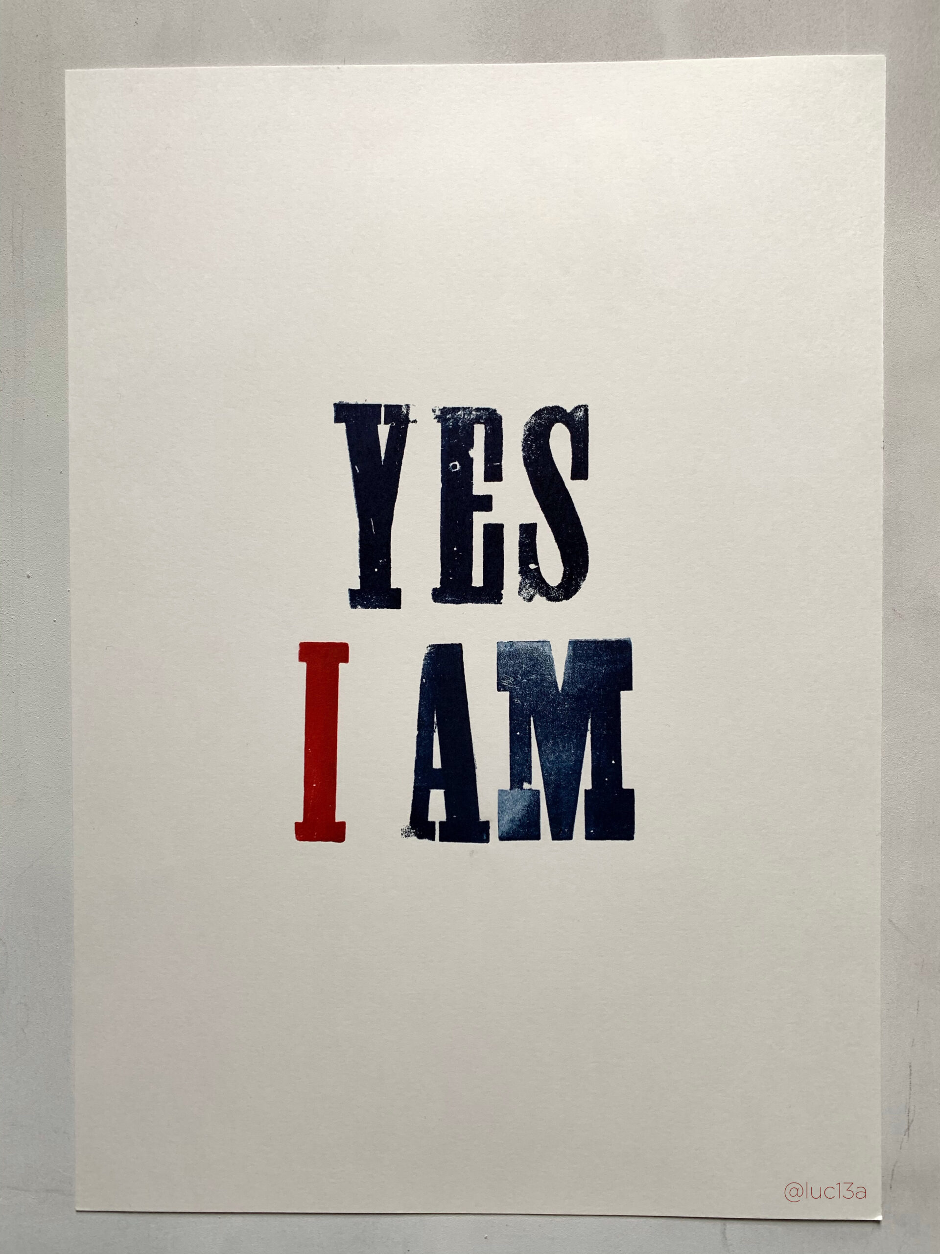 A poster that has the words "YES I AM" printed on it
