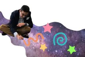 Man sitting on the ground drawing doodles on a background image of space