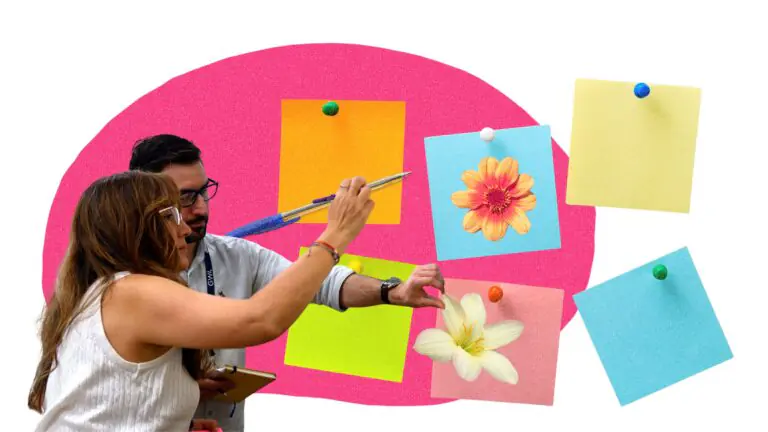 Two participants putting ideas on big post it notes with flowers in the foreground and a pink oval in the background